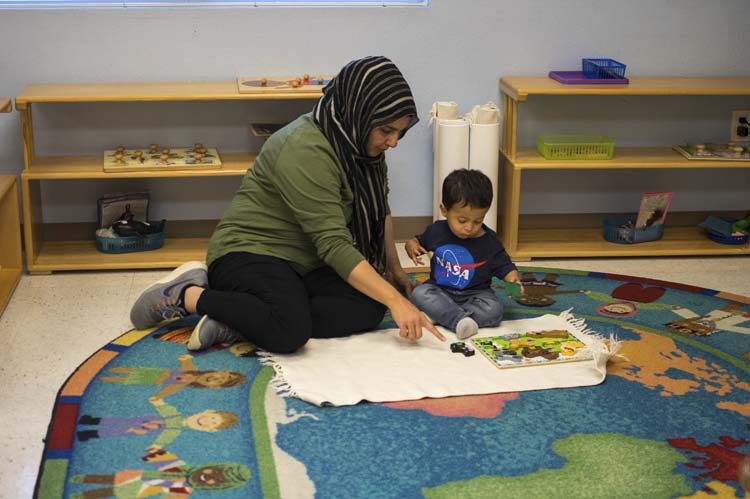 A teacher showing a toddler a new lesson in the Magnolia and Willow rooms at the Murphy campus
